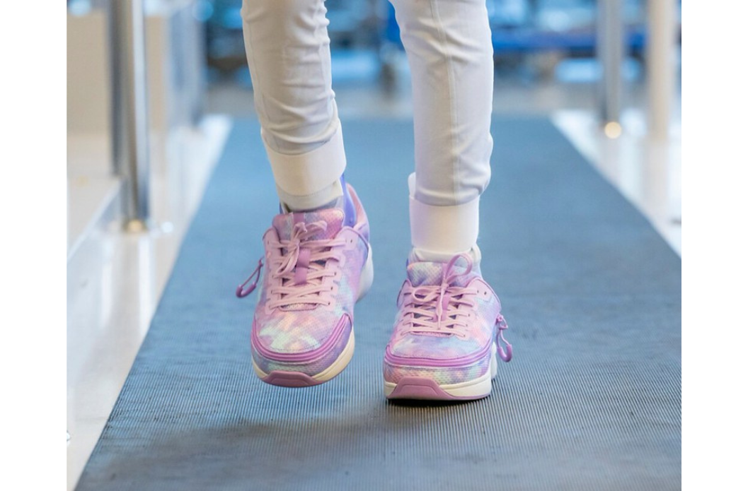 Child wearing adaptive sneakers designed to fit over SMO or AFO braces.