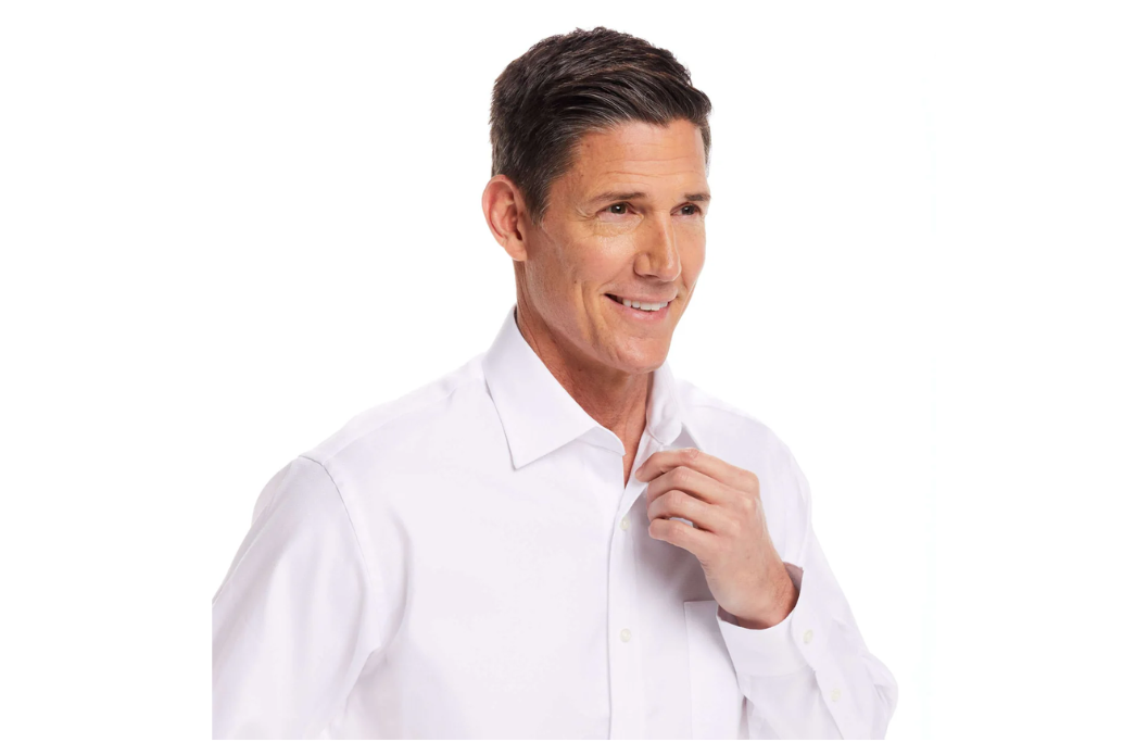 Man fastening a white MagnaReady magnetic dress shirt using one hand.