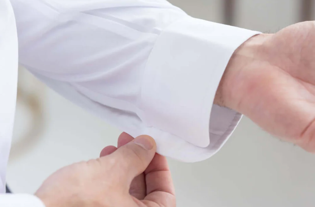 Magnetic closure being fastened on a white shirt cuff