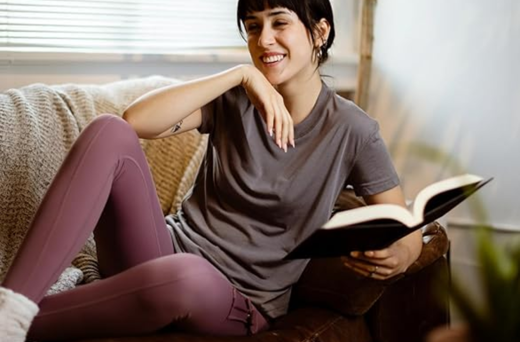 Person relaxing indoors wearing soft, comfortable clothing