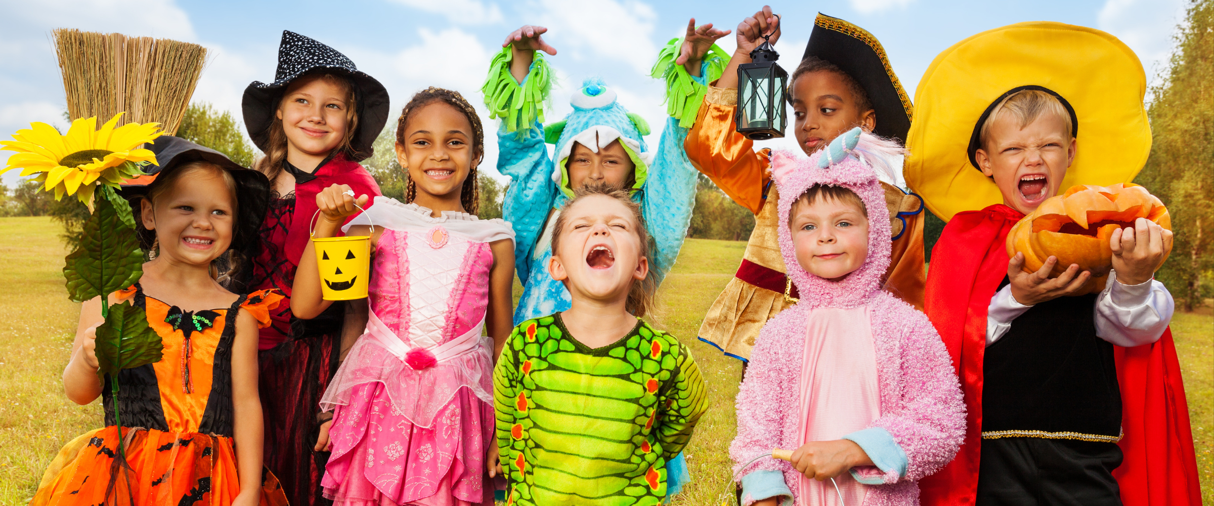 Children wearing adaptive and inclusive Halloween costumes outdoors during fall festivities