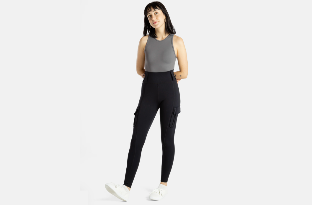 Woman wearing No Limbits black adaptive cargo leggings with side pockets, full-length front view