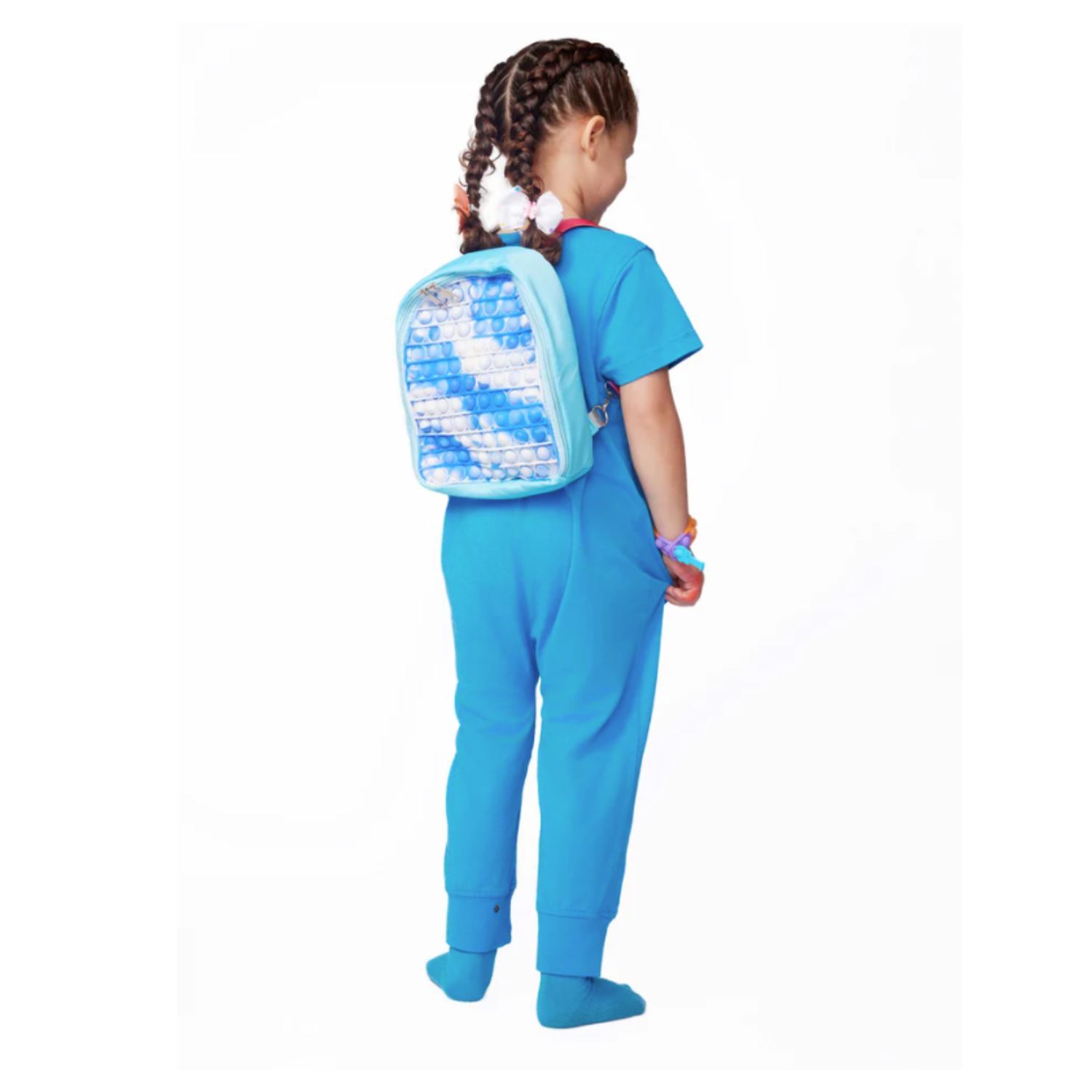 Young girl wearing a blue tie-dye pop-it sensory fidget backpack, rear view