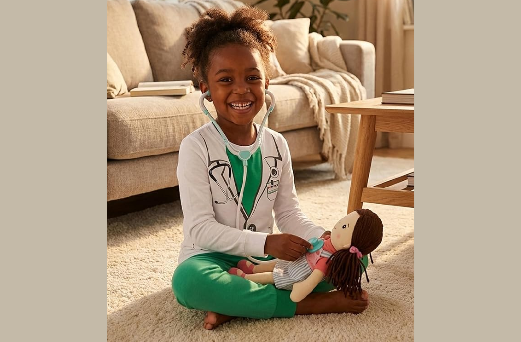 Child wearing soft character-themed pajamas while sitting comfortably indoors with a doll